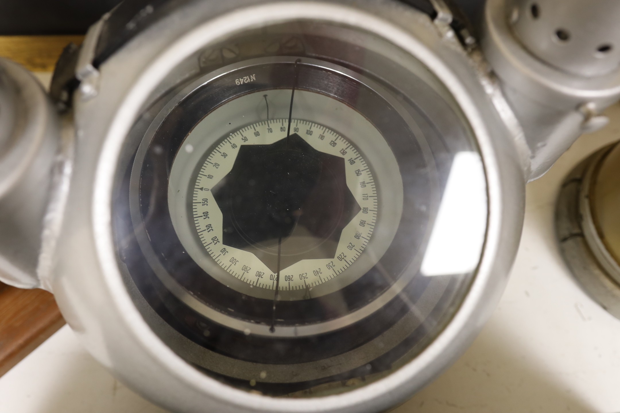 A World War Two gun-sight, ship's binnacle, barograph, etc.